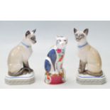 THREE CAT FIGURINES BY ROYAL WORCESTER AND HALCYON DAYS TO INCLUDE THE SIAMESE CAT AND GILES CAT.