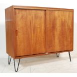 1970’S TEAK WOOD SIDEBOARD WITH SLIDING DOORS RAISED ON HAIRPIN SUPPORTS