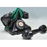 AN EARLY 20TH CENTURY BAKELITE RING DIAL TELEPHONE