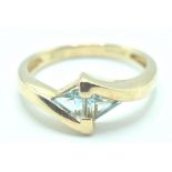 9CT GOLD AND BLUE TOPAZ CROSSOVER RING