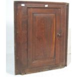A George III 19th century country oak hanging corner cabinet