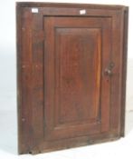 A George III 19th century country oak hanging corner cabinet