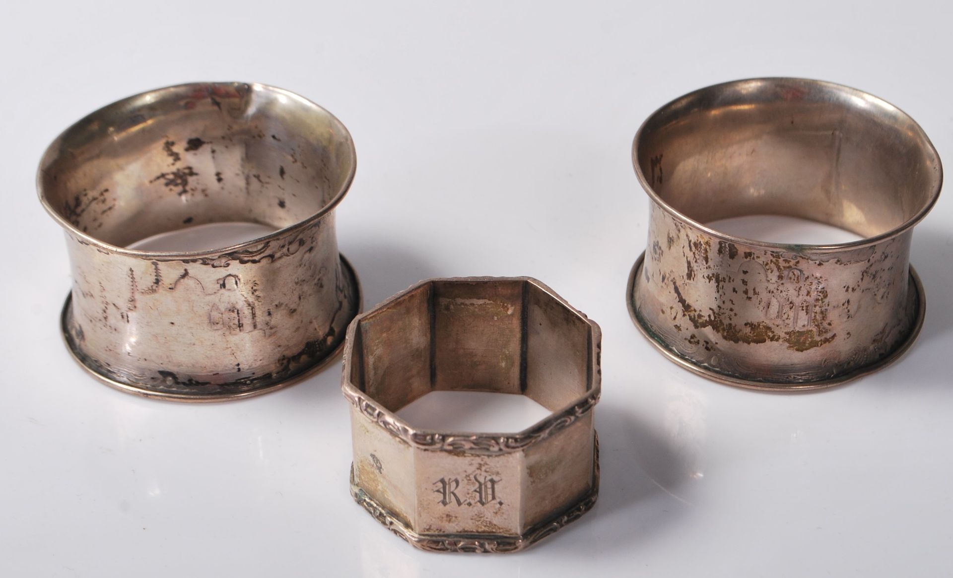 THREE ANTIQUE SILVER NAPKIN RINGS