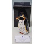 A ROYAL CROWN DERBY ROCKHOPPER PENGUIN PAPERWEIGHT WITH GOLD STOPPER