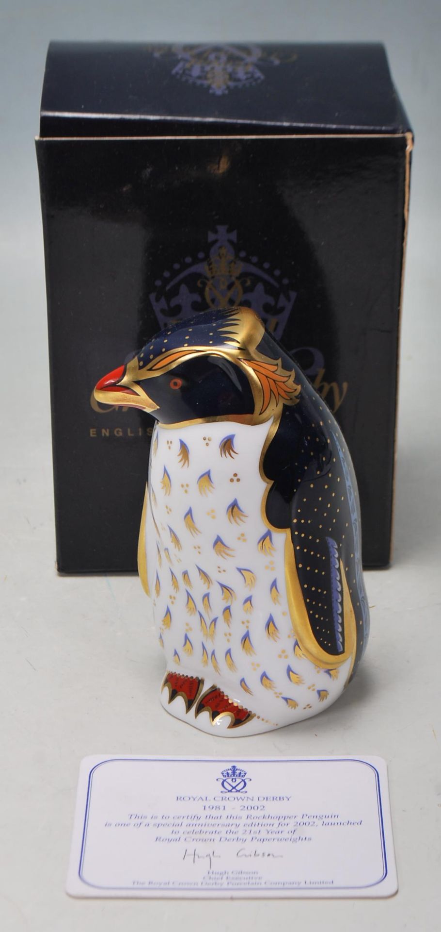 A ROYAL CROWN DERBY ROCKHOPPER PENGUIN PAPERWEIGHT WITH GOLD STOPPER