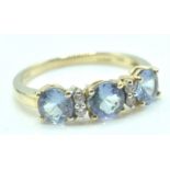 9CT GOLD DRESS RING WITH THREE PALE BLUE STONES SETTING
