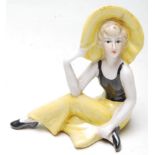 ART DECO 1930S STYLE CERAMIC FIGURINE OF A SEATED FLAPPER GIRL