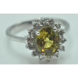 9CT WHITE GOLD RING WITH A PALE GREEN STONE