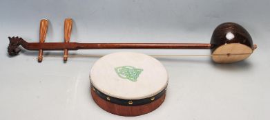 CHINESE ORIENTAL ERHU MUSICAL INSTRUMENT AND A HAND DRUM