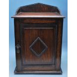 EARLY 20TH CENTURY OAK SMOKERS CABINET WITH GALLERY BACK