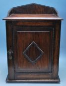 EARLY 20TH CENTURY OAK SMOKERS CABINET WITH GALLERY BACK