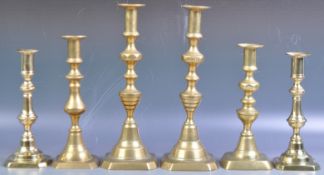 THREE PAIRS OF GEORGIAN ENGLISH TURNED BRASS CANDLESTICKS