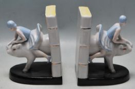 A PAIR OF ART DECO STYLE CERAMIC BOOKENDS