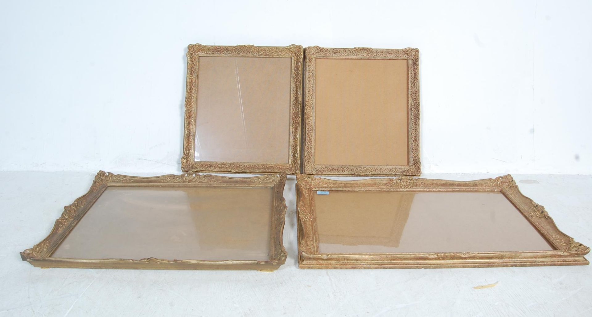 FOUR BAROQUE STYLE GILDED PICTURE FRAMES