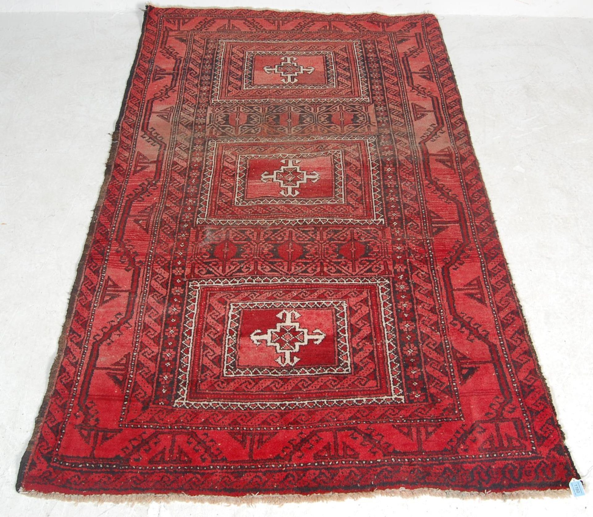 AN EARLY 20TH CENTURY PERISAN ISLAMIC RUG