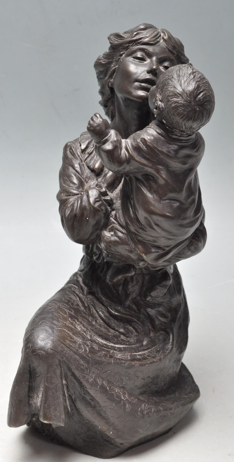 20TH CENTURY ANTIQUE STYLE BRONZED RESIN FIGURE OF A MOTHER AND CHILD.