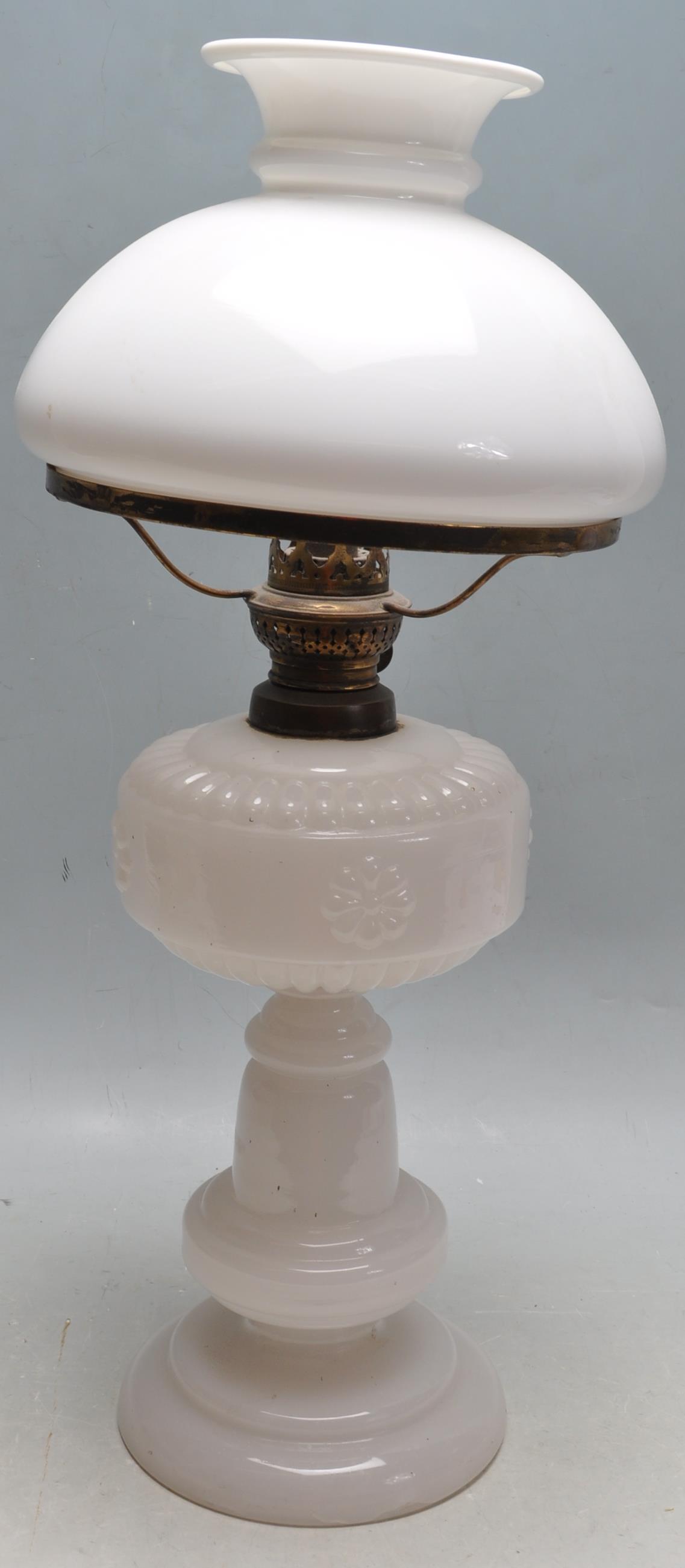 EARLY 20TH CENTURY MILK GLASS OIL LAMP AND SHADE