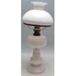 EARLY 20TH CENTURY MILK GLASS OIL LAMP AND SHADE