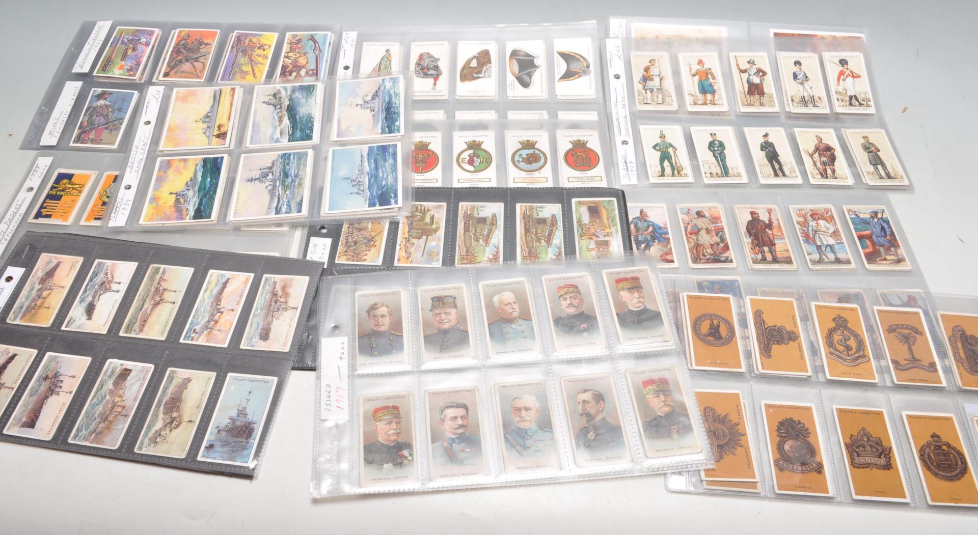 TWELVE SETS OF MILITARY THEMED TRADE CARDS AND CIGARETTE CARD MOSTLY WAR TIME