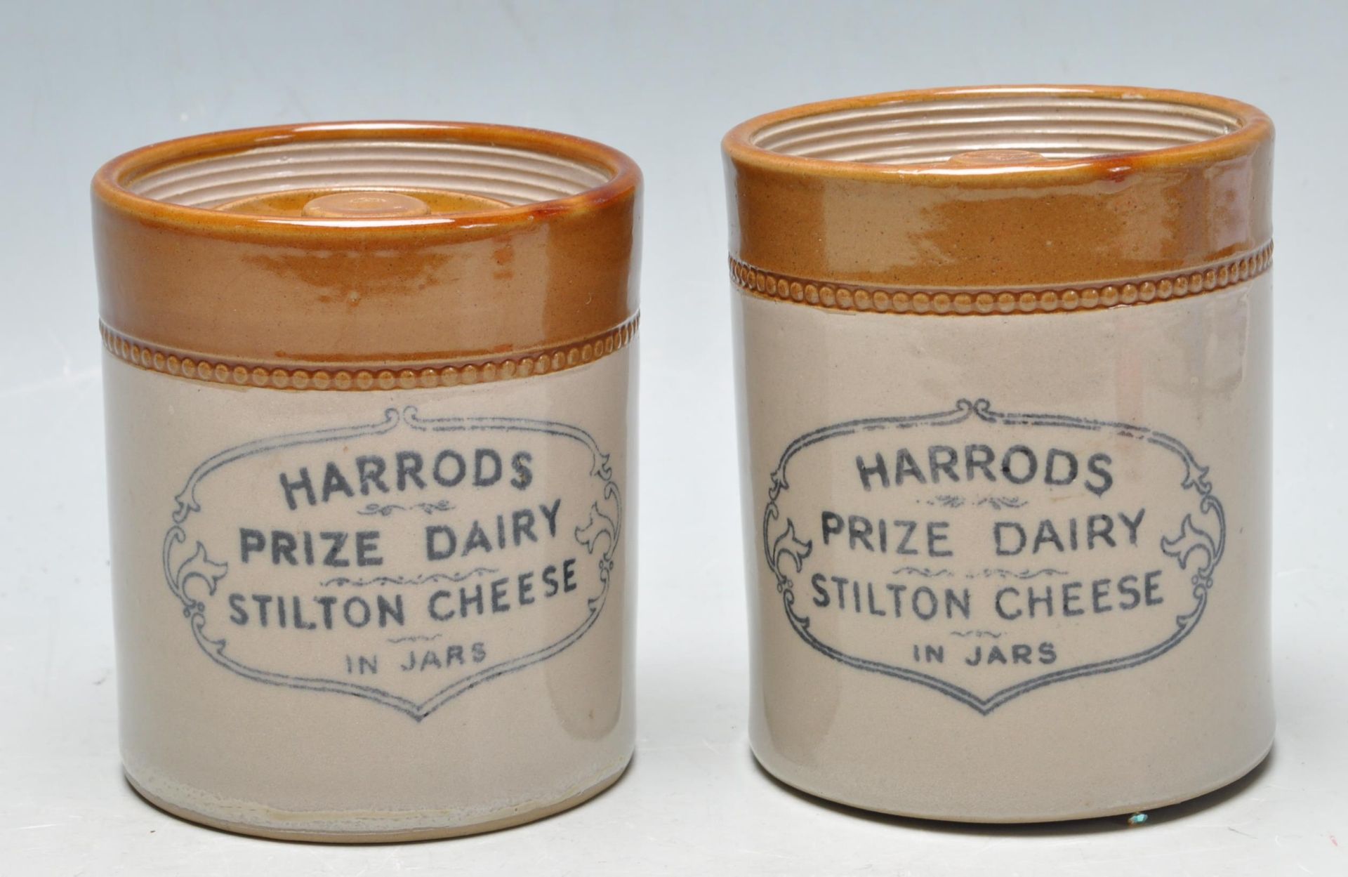 TWO ANTIQUE EARLY 20TH CENTURY STONEWARE JARS FROM HARRODS