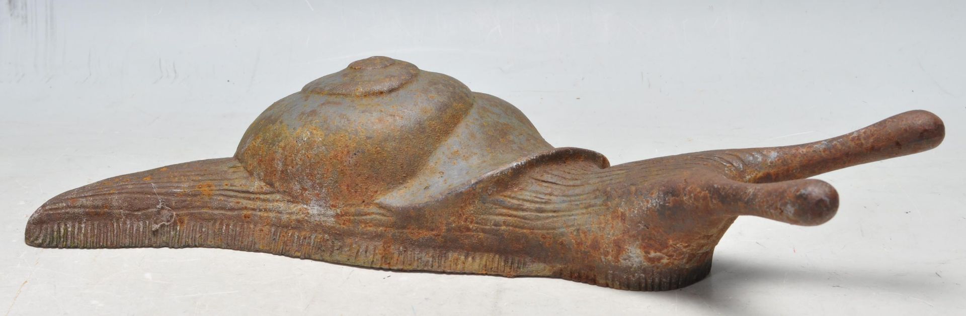 EARLY 20TH CENTURY CAST IRON BOOT JACK IN THE FORM OF A SNAIL