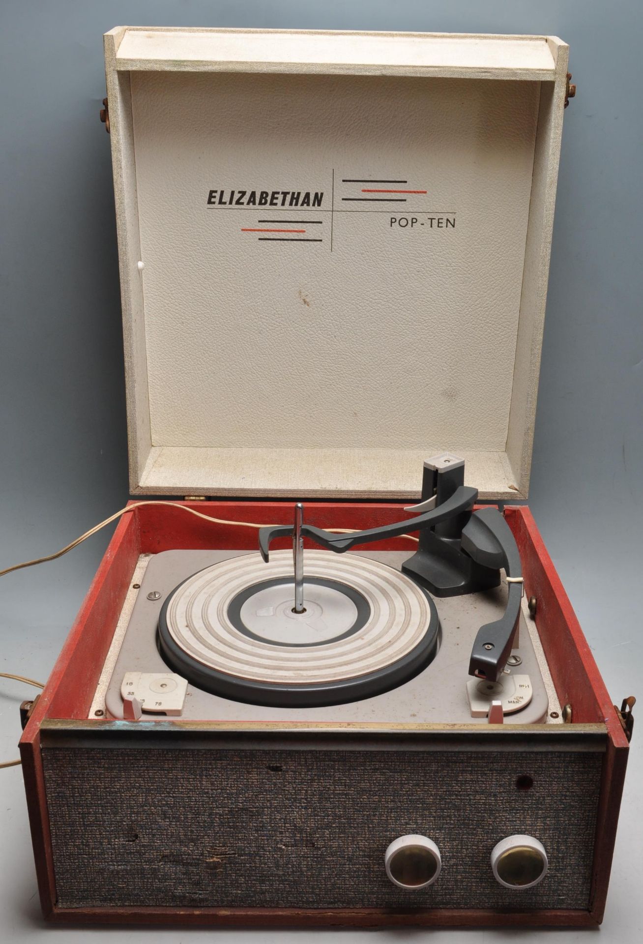 A VINTAGE RETRO ELIZABETHAN POP TEN RECORD PLAYER IN RED AND CREAM