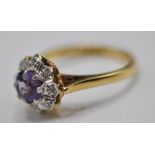 HALLMARKED 18CT GOLD LADIES RING WITH CENTRAL PURPLE STONE