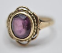 A 9CT GOLD & PURPLE STONE RING