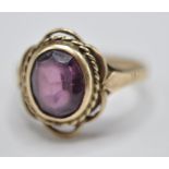 A 9CT GOLD & PURPLE STONE RING