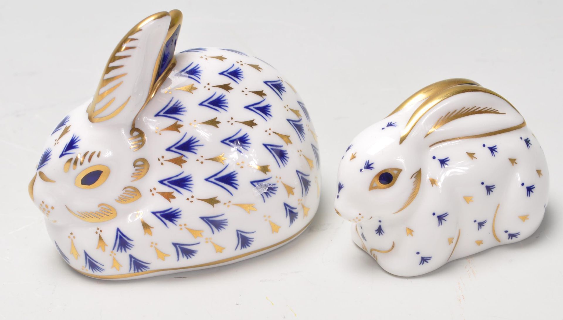 TWO ROYAL CROWN DERBY RABBIT PAPERWEIGHTS WITH GOLD STOPPERS