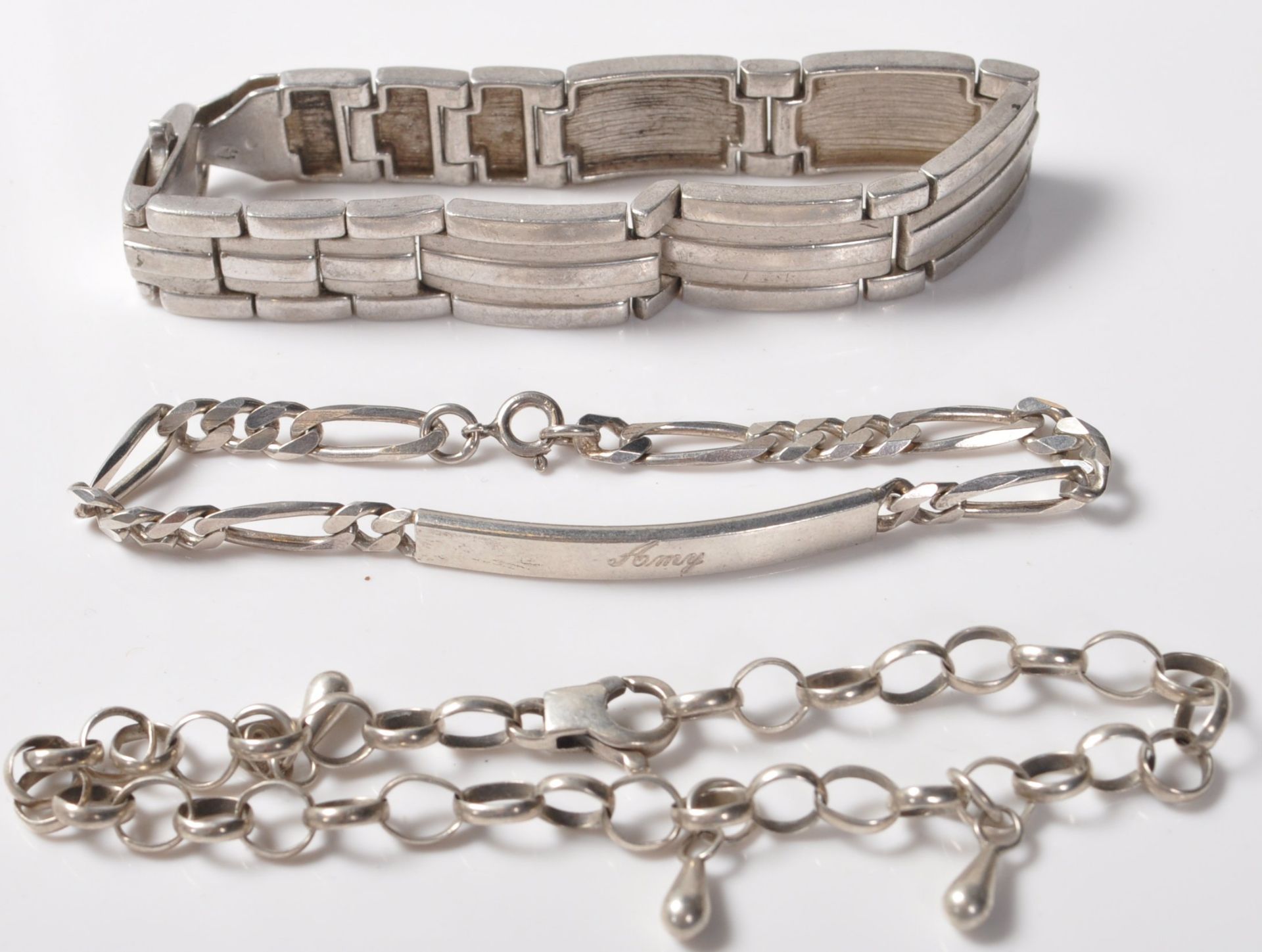 COLLECTION OF THREE SILVER STAMPED 925 BRACELETS.