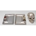 TWO VINTAGE LESNEY CAR ASHTRAYS AND A DESKTOP SKULL