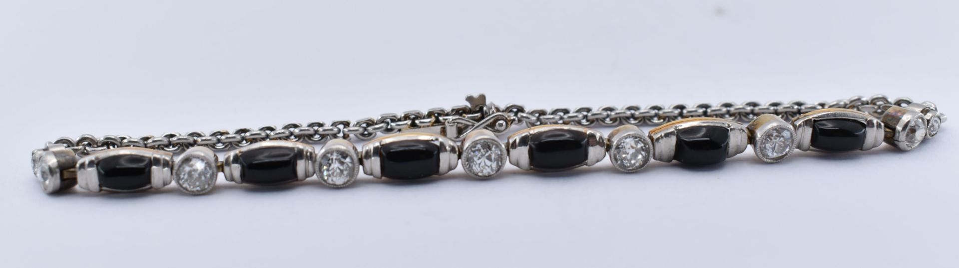 A PLATINUM GOLD ONYX & DIAMOND BRACELET