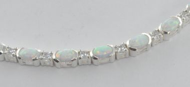 STAMPED 925 SILVER AND OPAL LADIES TENNIS BRACELET.