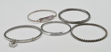 FIVE SILVER BANGLE BRACELETS