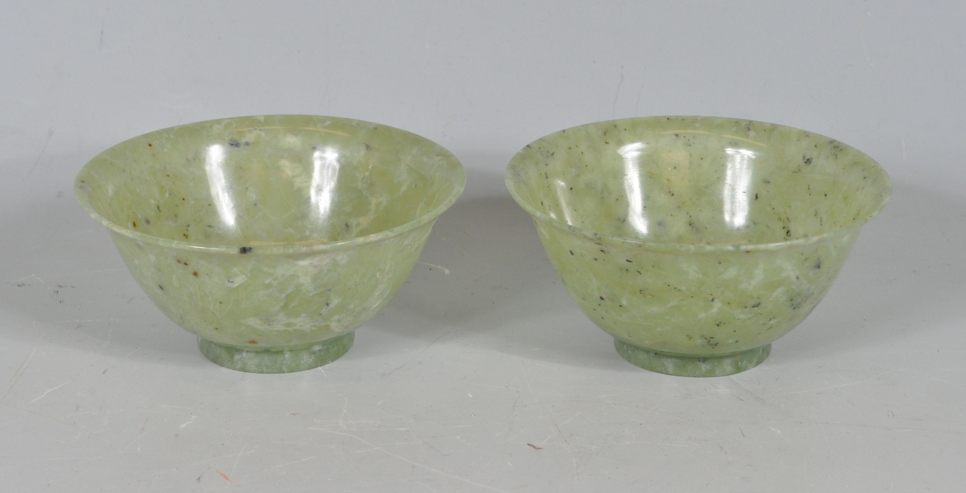 TWO CHINESE ORIENTAL GREEN JADE COLOURED RICE BOWLS.