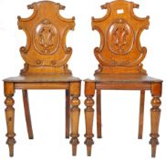 PAIR OF ANTIQUE ORNATE ARMORIAL CARVED OAK HALL CHAIRS