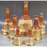 COLLECTION OF BELLS CERAMIC WHISKY DECANTERS