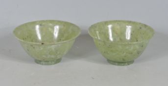 TWO CHINESE ORIENTAL GREEN JADE COLOURED RICE BOWLS.