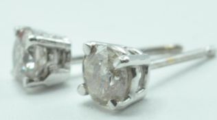 PAIR OF 14CT WHITE GOLD DIAMOND STUD EARRINGS.