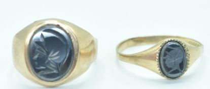 TWO GOLD AND BLACK STONE CAMEO RINGS