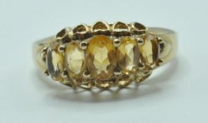 9CT GOLD AND FIVE YELLOW STONE RING