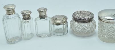 COLLECTION OF SIX ANTIQUE SILVER LIDDED VANITY POTS AND PERFUME BOTTLES.