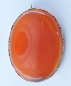 19TH CENTURY VICTORIAN YELLOW METAL / GOLD AND ORANGE STONE BROOCH