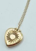 STAMPED 9CT GOLD HEART SHAPED LOCKET UPON 9CT GOLD CHAIN.