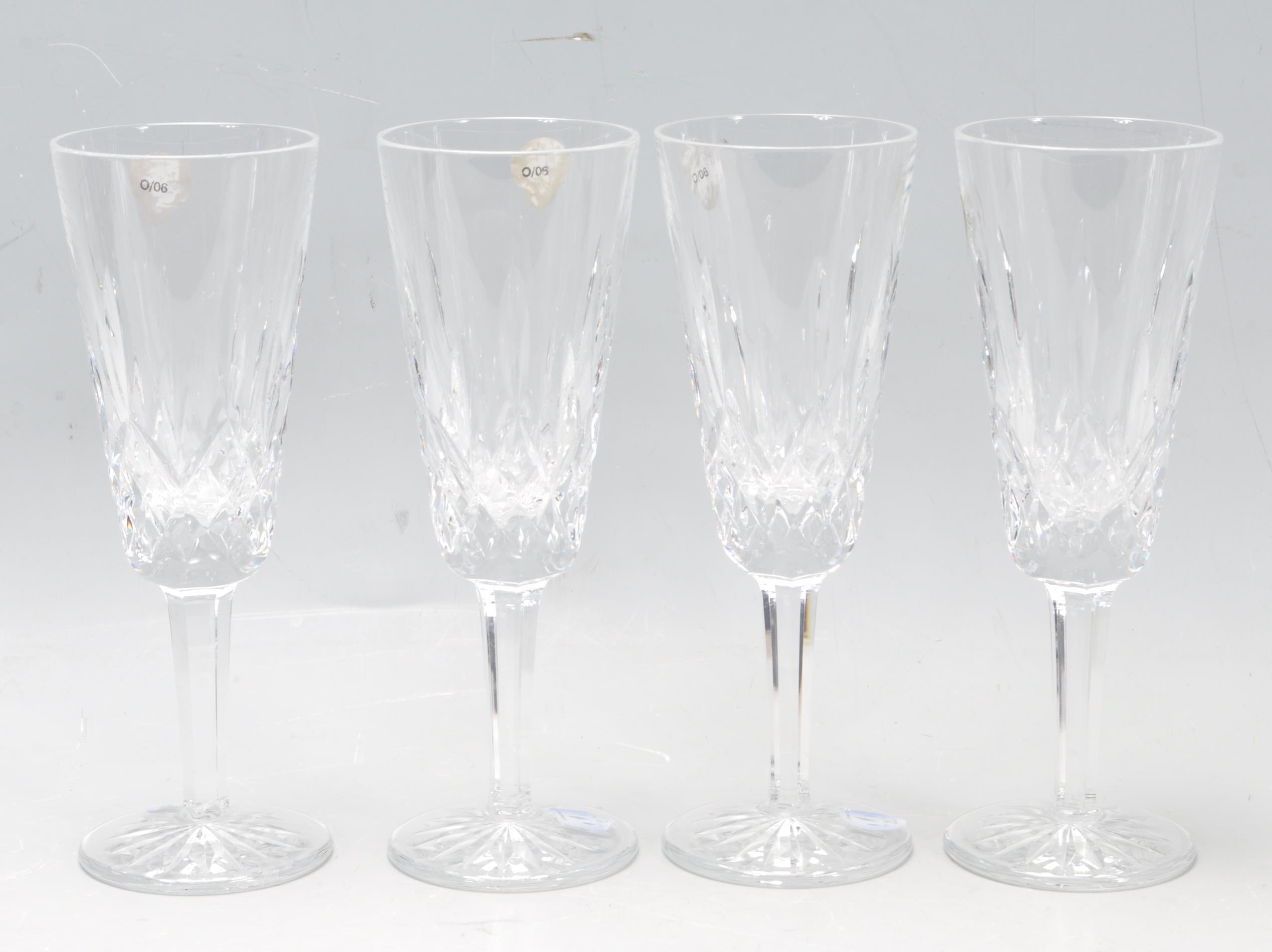 SET OF FOUR LISMORE PATTERN WATERFORD CRYSTAL CHAMPAGNE FLUTE GLASSES