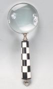 LARGE HANDHELD MAGNIFYING GLASS WITH CHECK HANDLE.