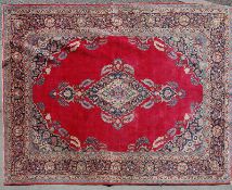 A mid 20th century Persian Islamic Sarouk handwoven wool carpet rug having foliate decoration to the