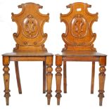 PAIR OF ANTIQUE ORNATE ARMORIAL CARVED OAK HALL CHAIRS