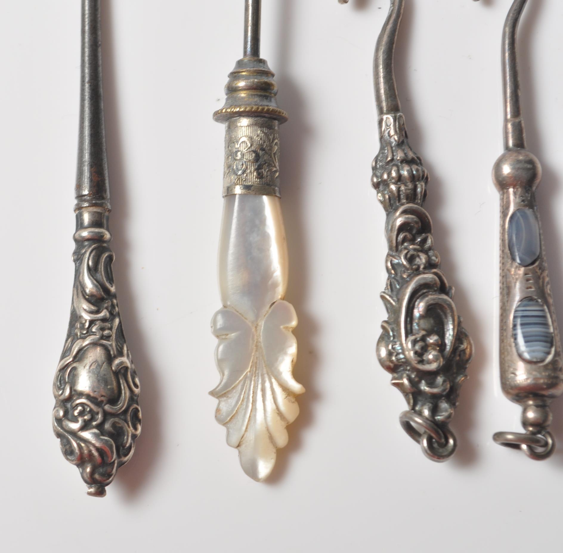 COLLECTION OF FOUR VICTORIAN SILVER BUTTON HOOKS WITH AGATE AND MOTHER OF PEARL HANDLES. - Image 2 of 8